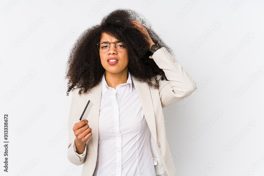 Young afro business woman holding a credit car isolated Young afro business woman holding a credit carbeing shocked, she has remembered important meeting.