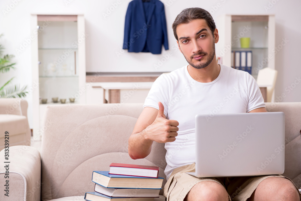Young male student preparing for exams at home Young male student preparing for exams at home