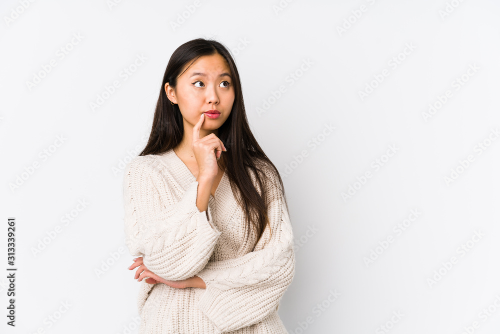 Young chinese woman isolated looking sideways with doubtful and skeptical expression. Young chinese woman isolated looking sideways with doubtful and skeptical expression.