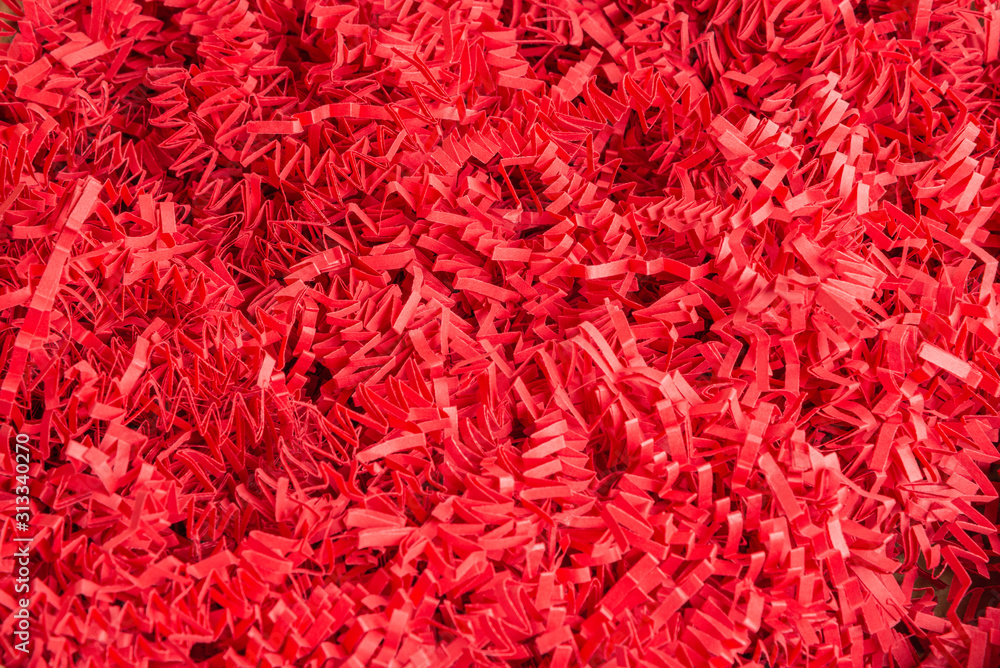 Red Paper Strips Filling From A Package Box