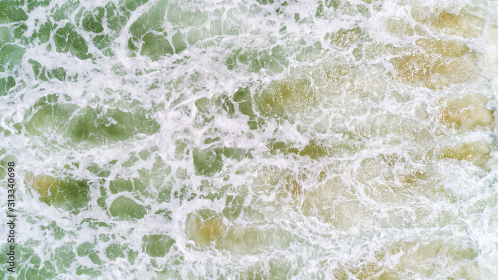 Top view nature landscape of Flowing wave white seafoam turquoise waves Beautiful tropical sea in summer season image by Aerial view drone shot, high angle view Top down. Top view nature landscape of Flowing wave white seafoam turquoise waves Beautiful tropical sea in summer season image by Aerial view drone shot, high angle view Top down.