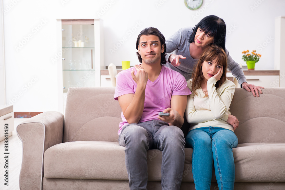 Young family and mother-in-law in family issues concept Young family and mother-in-law in family issues concept