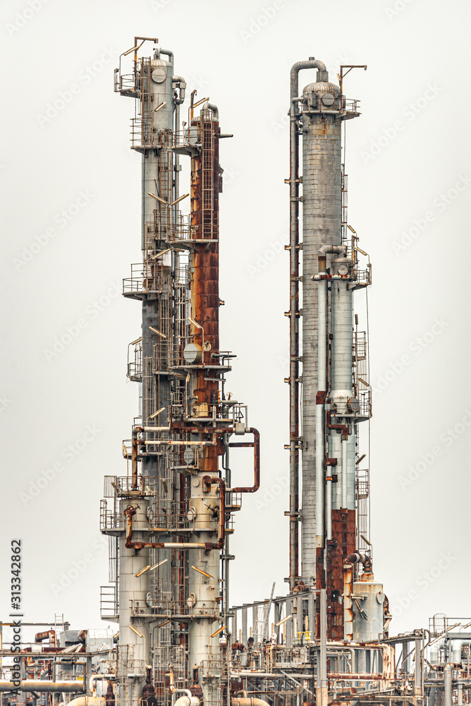 Pipelines of a oil and gas refinery industrial plant on a over cast day Pipelines of a oil and gas refinery industrial plant on a over cast day