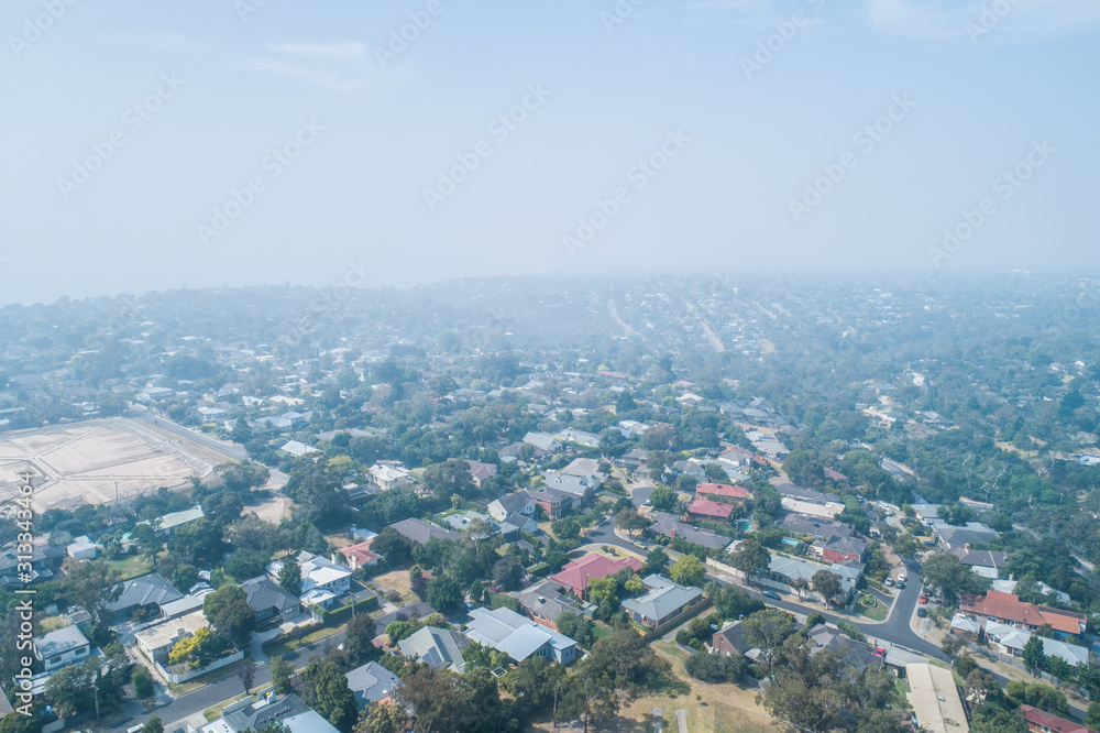 Aerial view of homes unders heavy smoke haze from bush fires in Victoria, Australia