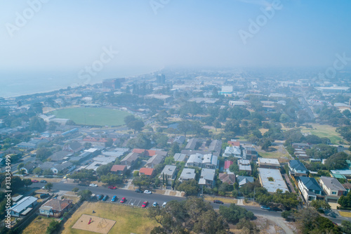 Heavy smoke haze covering suburbs in Victoria, Australia - aerial view