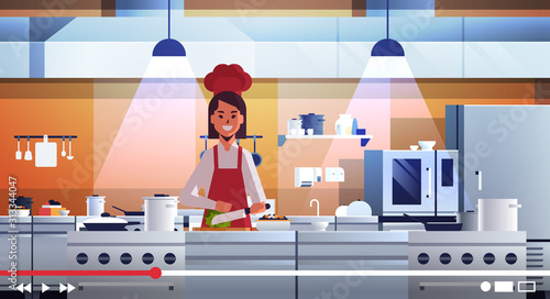 food blogger recording online video female chef in uniform cooking in kitchen blogging concept woman vlogger explaining how to cook a dish portrait horizontal vector illustration