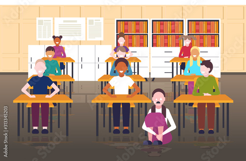 depressed schoolgirl being bullied by mix race schoolmates peer violence victim of bullying mocking public disapproval concept modern school classroom interior full length horizontal vector