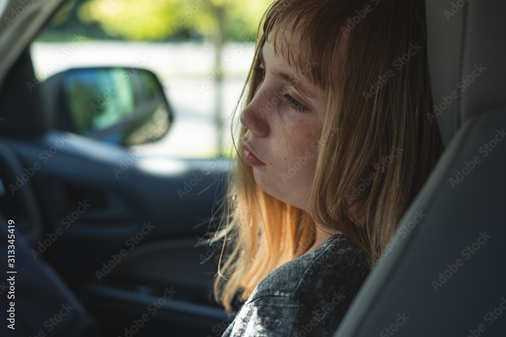 Sad/Depressed teen girl sitting in a car/suv while being driven to/picked up from school.