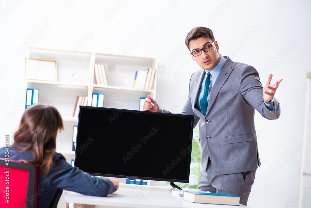 Young employee making presentation to his female boss