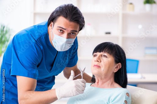 Old woman visiting male doctor for plastic surgery