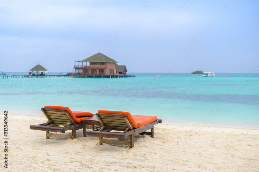 Beautiful beach. Chairs on the sandy beach near the sea. Summer holiday and vacation concept for tourism. 