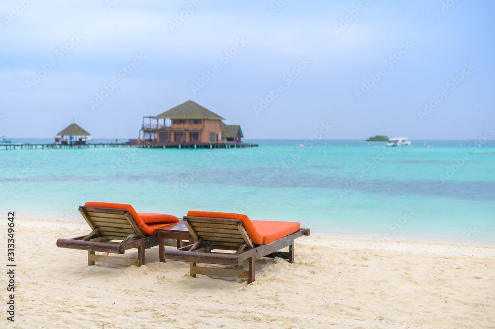 Beautiful beach. Chairs on the sandy beach near the sea. Summer holiday and vacation concept for tourism. Beautiful beach. Chairs on the sandy beach near the sea. Summer holiday and vacation concept for tourism.