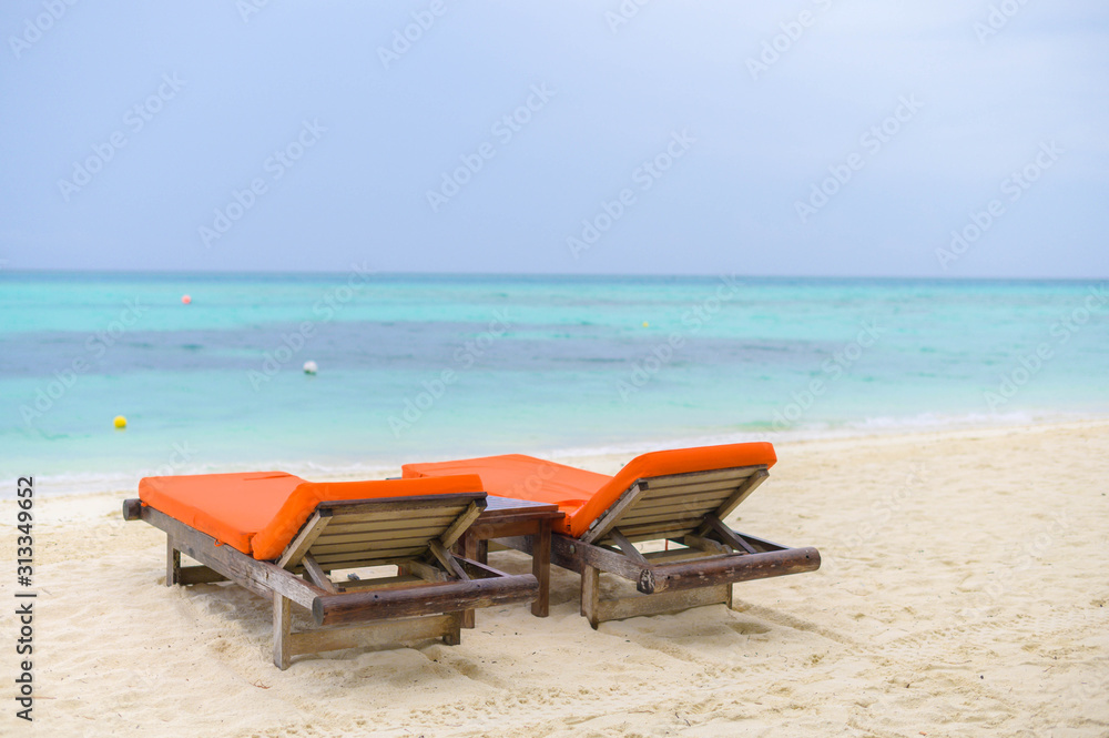 Beautiful beach. Chairs on the sandy beach near the sea. Summer holiday and vacation concept for tourism. Beautiful beach. Chairs on the sandy beach near the sea. Summer holiday and vacation concept for tourism.