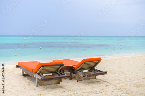 Beautiful beach. Chairs on the sandy beach near the sea. Summer holiday and vacation concept for tourism. 