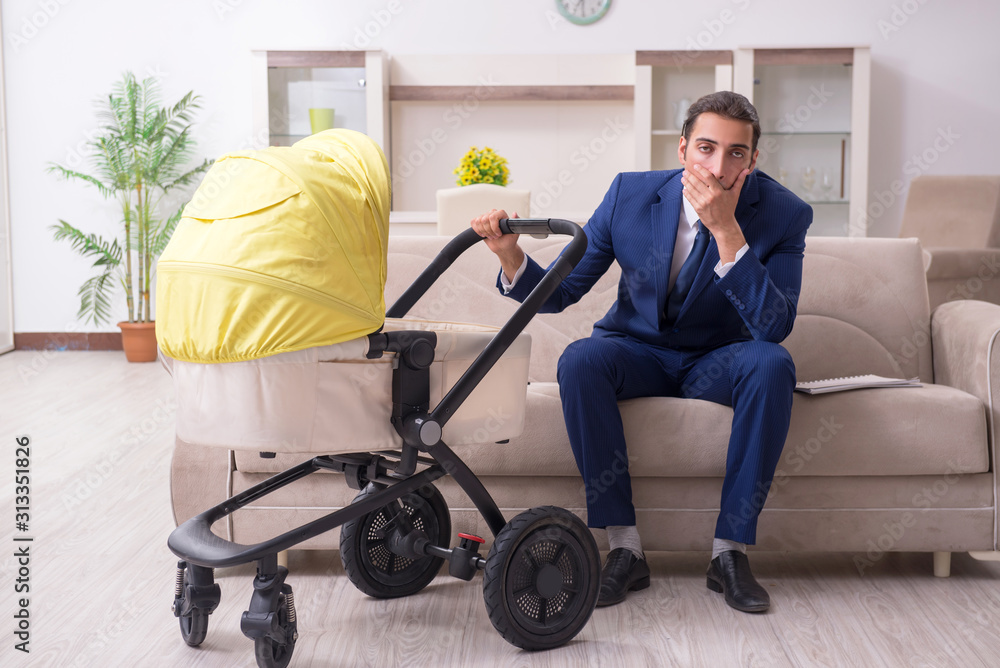 Young businessman looking after baby Young businessman looking after baby