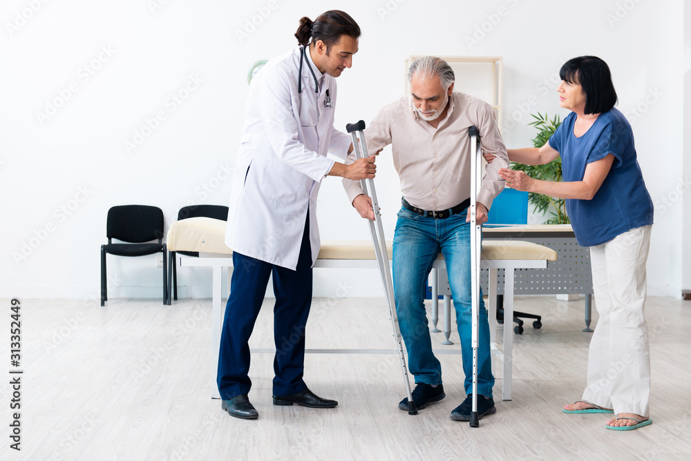 Old couple visiting young male doctor Old couple visiting young male doctor