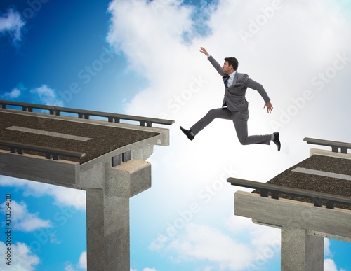 Young businessman jumping over the bridge