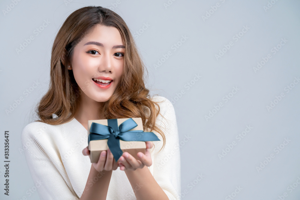 smart casual asian beautiful female smile hand show brown gift present box with ribbon with cheerful white background smart casual asian beautiful female smile hand show brown gift present box with ribbon with cheerful white background