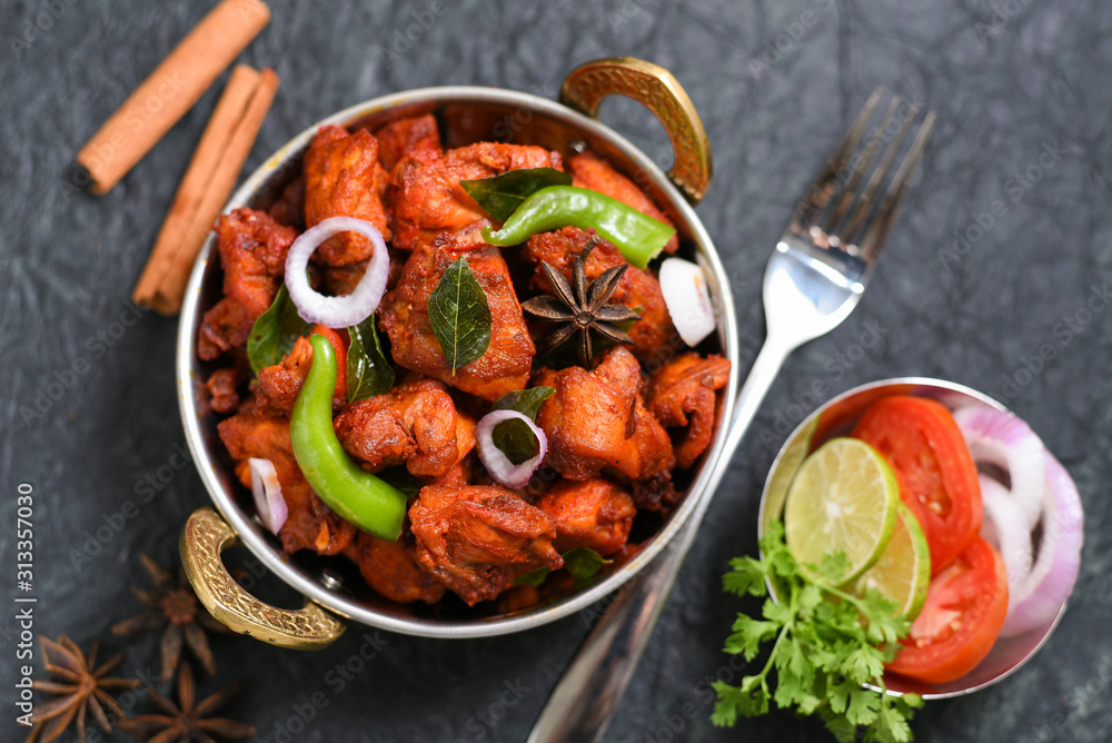 Fried chicken Kebab or Kabab, Chicken Tikka Masala in copper Kadai on