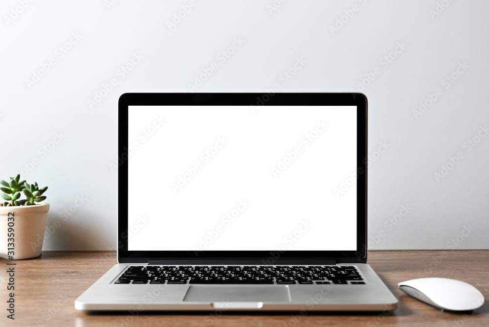 Laptop computer with blank screen in office Laptop computer with blank screen in office