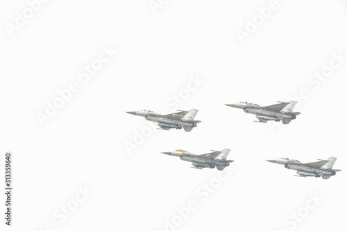 Combat aircraft practicing through the white background