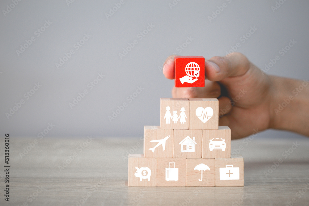 Hand arranging wood block stacking with icon insurance: car, real estate and property, travel, finances, health, family and life, insurance concept. Hand arranging wood block stacking with icon insurance: car, real estate and property, travel, finances, health, family and life, insurance concept.