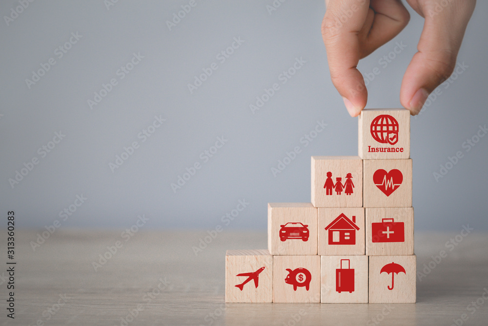 Hand arranging wood block stacking with icon insurance: car, real estate and property, travel, finances, health, family and life, insurance concept. Hand arranging wood block stacking with icon insurance: car, real estate and property, travel, finances, health, family and life, insurance concept.