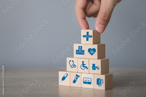 Health Insurance Concept,hand arranging wood block stacking with icon healthcare medical.