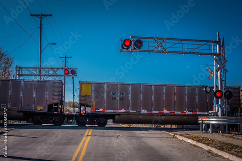 railroad crossing with train going thru