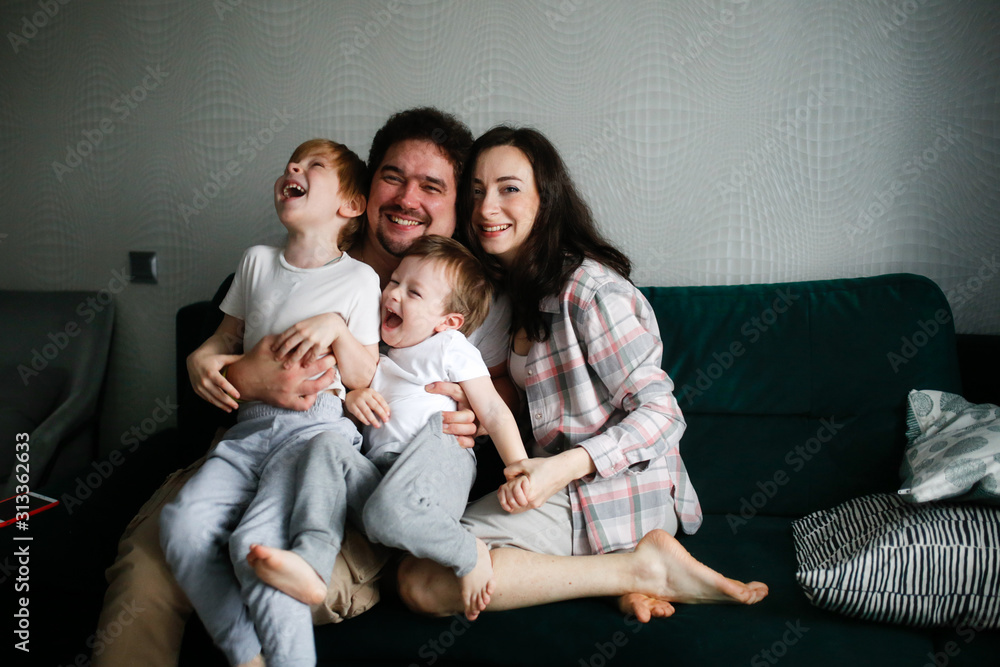 Authentic family with two children on sofa