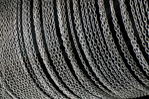 Lots of metal chains on a black background. Background of chains