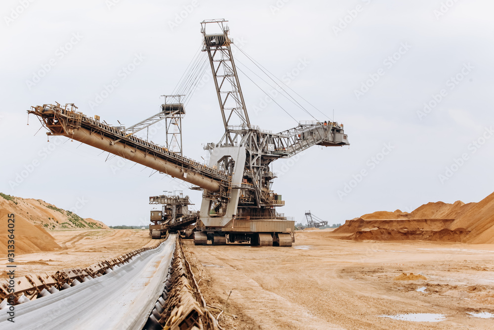 Giant bucket wheel excavator. The biggest excavator in the world. The largest land vehicle. Excavator in the mines. Giant bucket wheel excavator. The biggest excavator in the world. The largest land vehicle. Excavator in the mines.