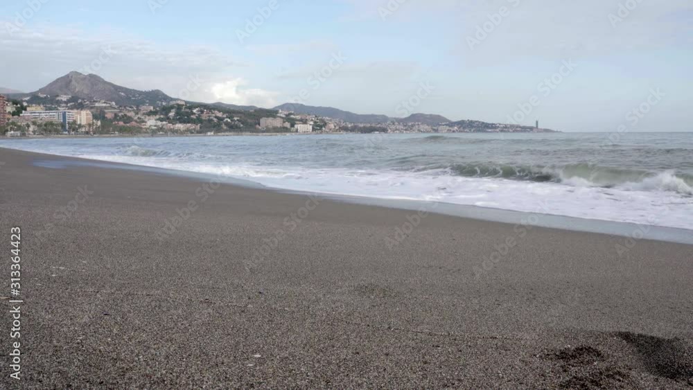 Empty Malagueta beach with Malaga city in the background, Spain, Costa del Sol Empty Malagueta beach with Malaga city in the background, Spain, Costa del Sol