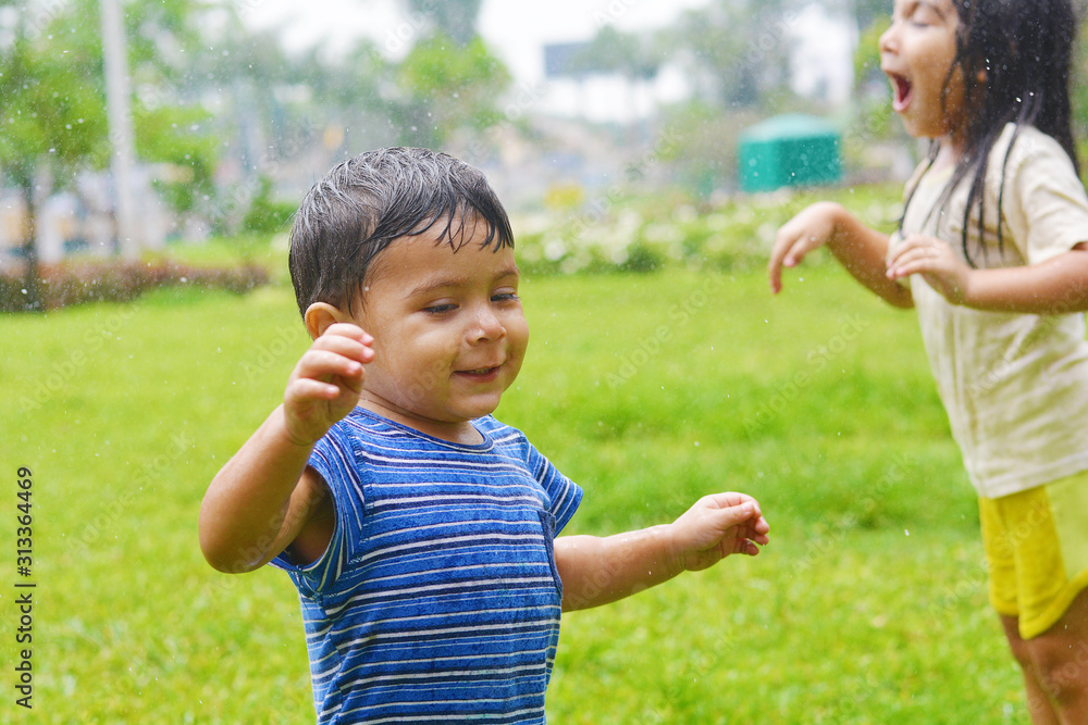 Emotional portrait of latin kids excited because of the rain. Emotional portrait of latin kids excited because of the rain.