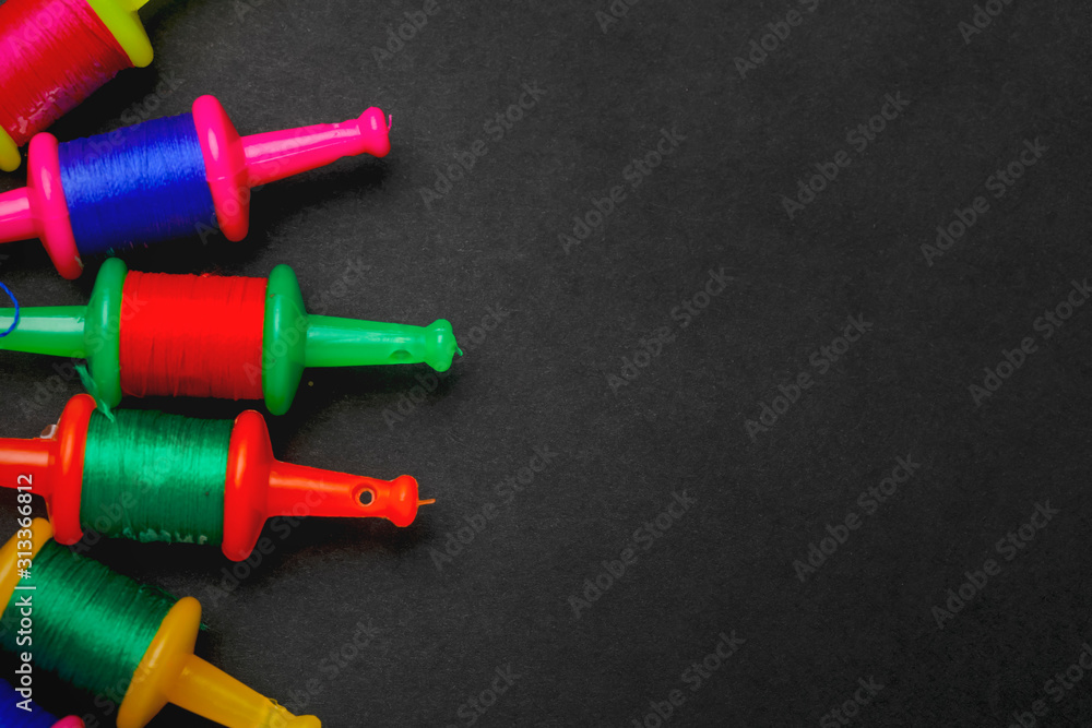 Spool with colourful thread or manjha or manja on dark background. Indian festival makar sankranti concept Spool with colourful thread or manjha or manja on dark background. Indian festival makar sankranti concept