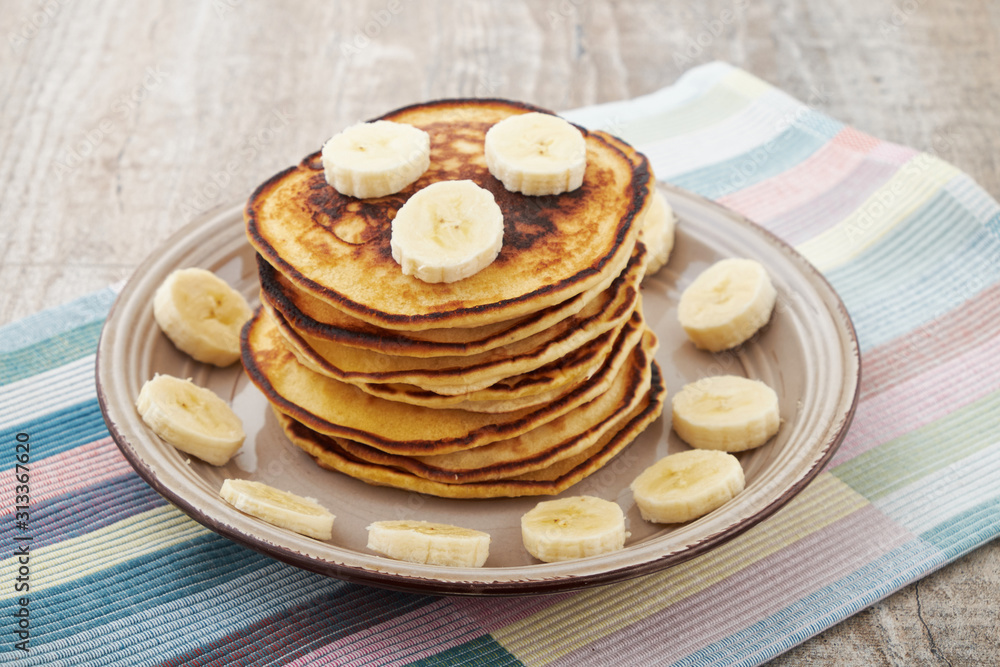 Pancakes with bananas almond and caramel sauce. selective focus.