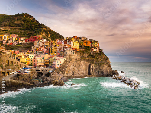 Manarola, Cinque Terre (Five Lands), Liguria, Italy: Beautiful sunset view of a village perched on a hill, typical colorful houses. The Cinque Terre National Park is a UNESCO World Heritage Site