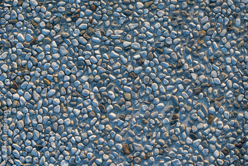 grey tile with a lot of small stones close up