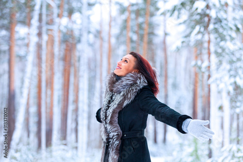 Happy pretty woman in a winter deep forest