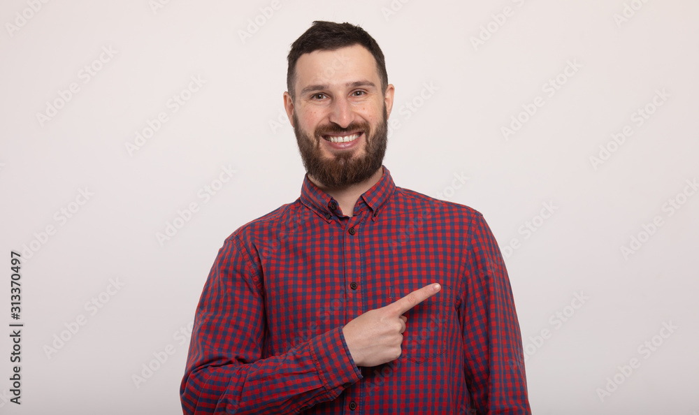 Laughing bearded man pointing to the side. Isolated on white background. Laughing bearded man pointing to the side. Isolated on white background.