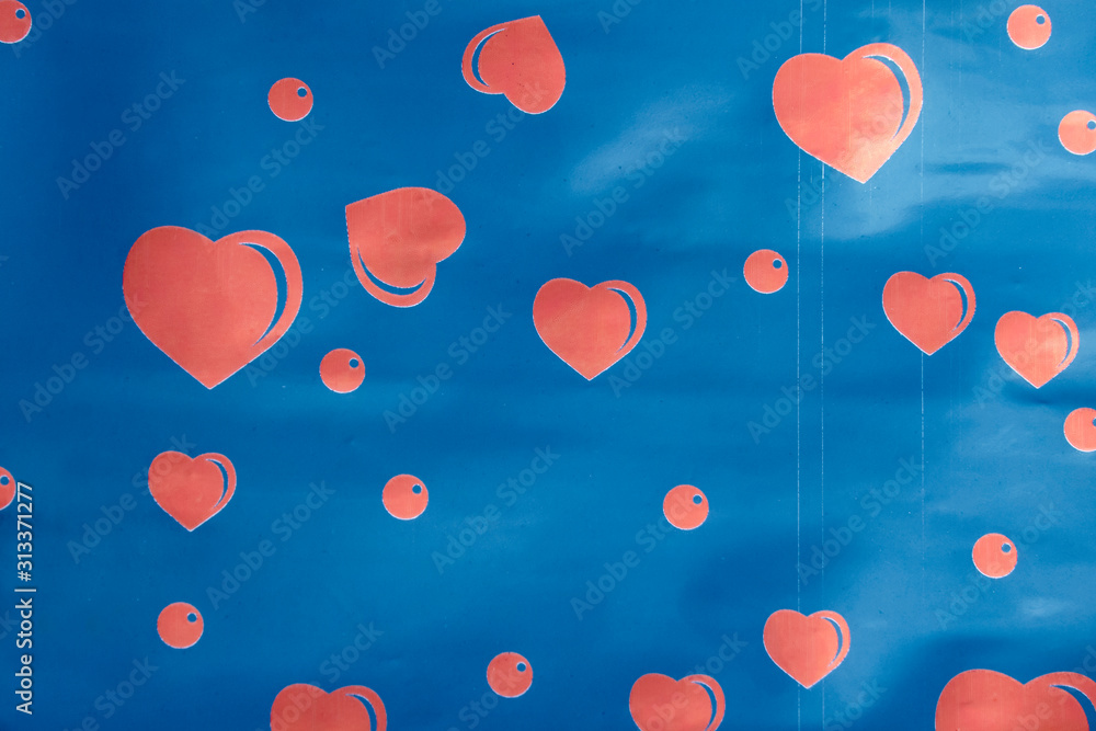 Red hearts of different sizes on a blue background with reflections.