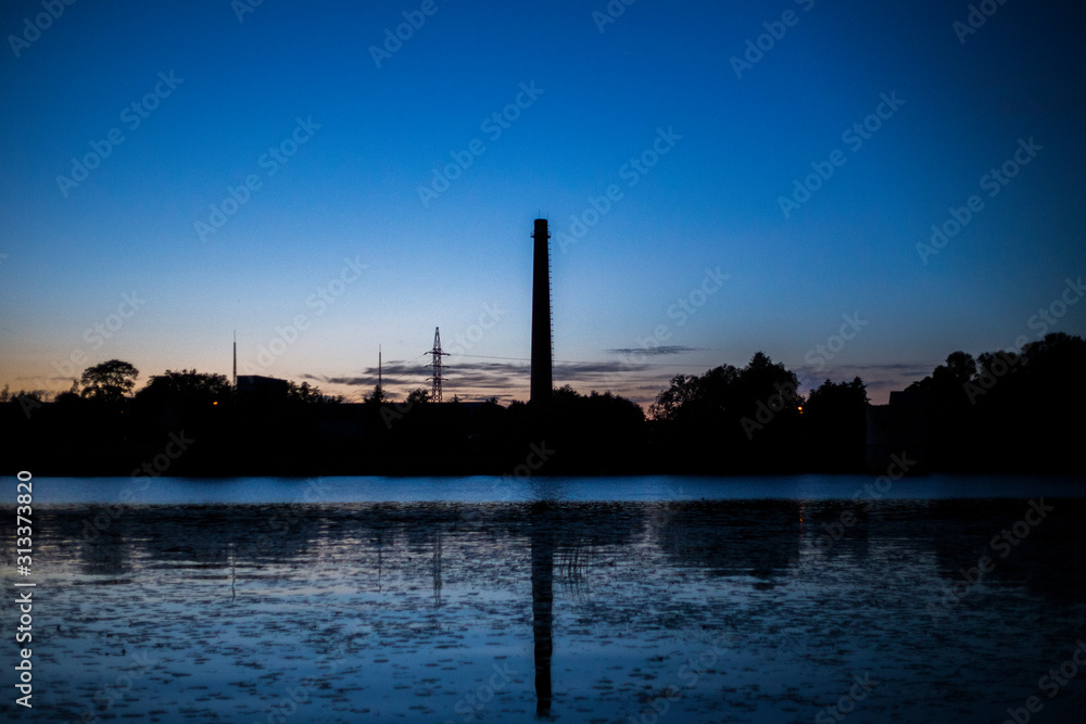 Obraz premium industrial factory at sunset