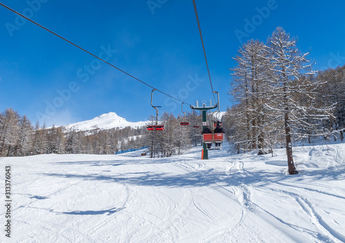Bardonecchia, Italian Alps, snowy scenery: ski slopes and chairlift (chair lift), ski resort and winter snow landscape. Photos with Snow