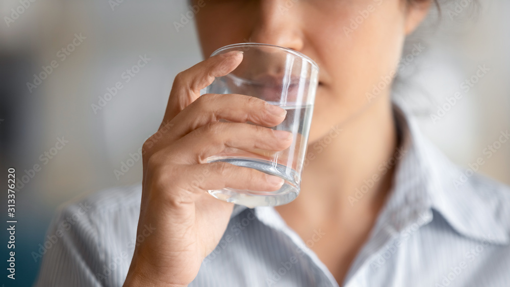 Healthy young lady drinking fresh clean water, close up view Healthy young lady drinking fresh clean water, close up view