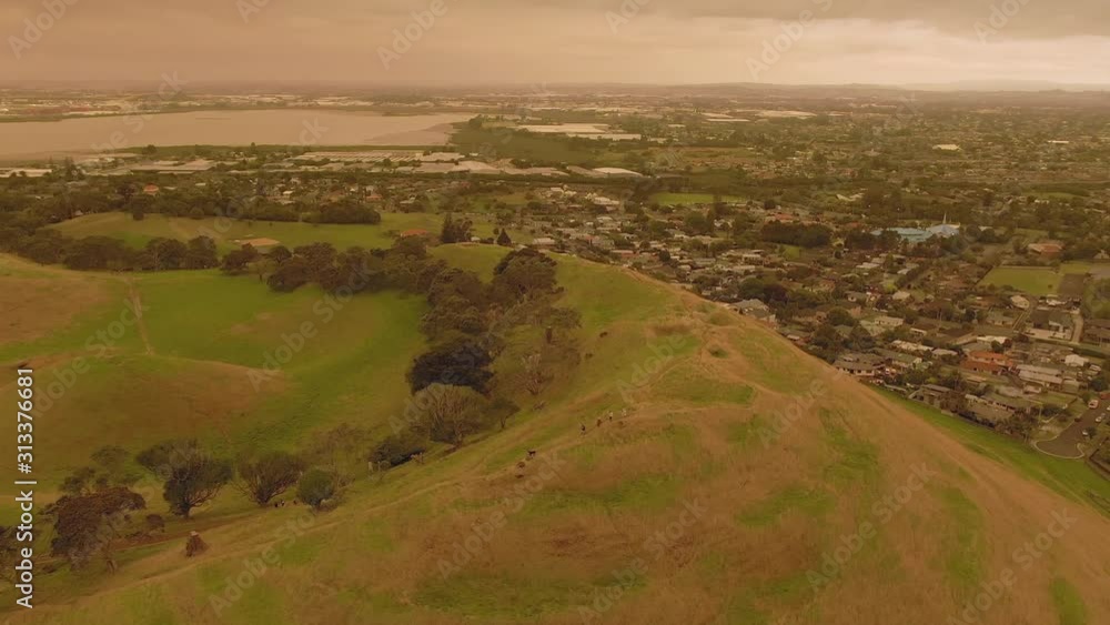 Aerial: Mangere Mountain and orange skies created from the Australian bush fires that swept accross the Tasman Sea. Auckland, New Zealand. 5 January 2019 Aerial: Mangere Mountain and orange skies created from the Australian bush fires that swept accross the Tasman Sea. Auckland, New Zealand. 5 January 2019