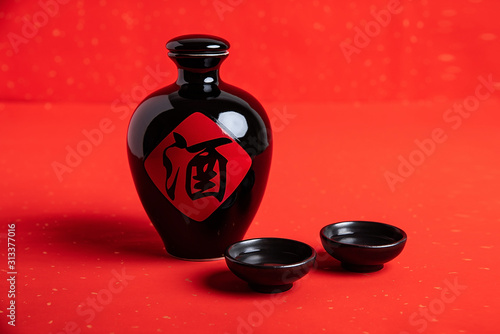 Chinese traditional brewed liquor in a jug on a red background photo