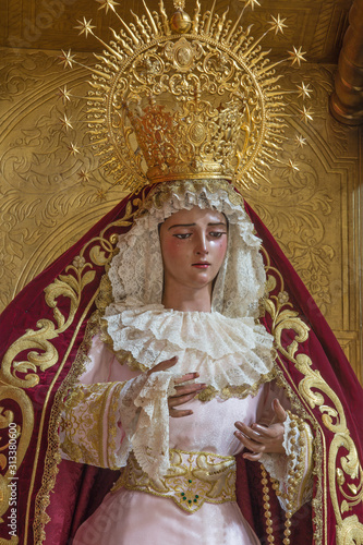 SEVILLE, SPAIN - OCTOBER 28, 2014: The detail of typically vested, cried Virgin Mary statue in church Iglesia de San Roque.