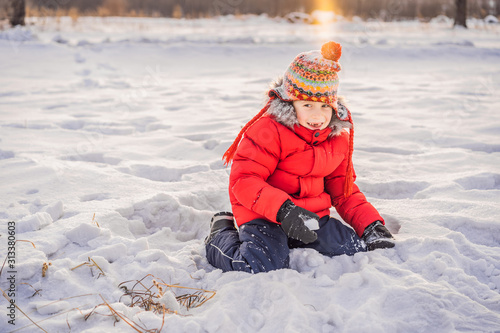 Little boy having fun in the snow