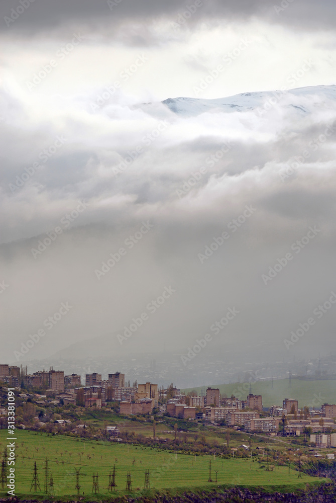 Alaverdi town on the background of the mountain and clouds. Lori Region, Armenia.