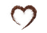 heart made of roasted coffee beans and ground coffee on a white background
